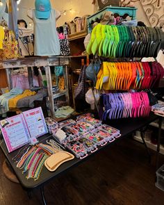 there are many items on the table in this store that is full of colorful shirts and ties