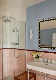 a bathroom with blue walls and pink tiles