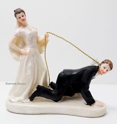 a figurine of a man pulling a woman on a rope