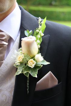 a man in a tuxedo with a boutonniere on his lapel