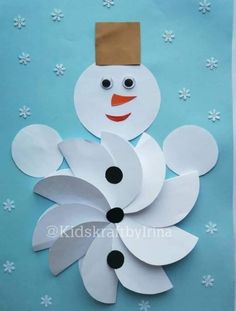 a snowman made out of paper on a blue background