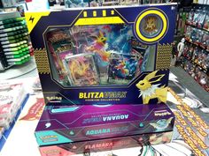 a display case with pokemon trading cards and action figures in it's box at a toy store