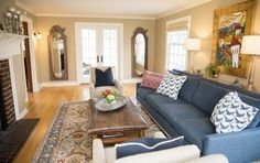 a living room filled with furniture and a fire place in the middle of a room