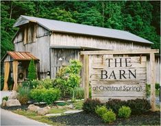 the barn at chestnut springs sign in front of it