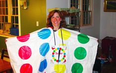 a woman holding up a large polka dot kite