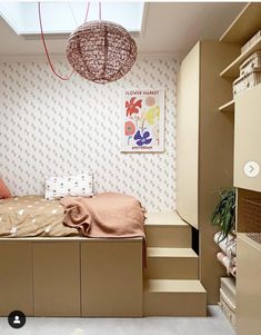 a bed sitting under a window in a bedroom next to a dresser and shelf filled with drawers