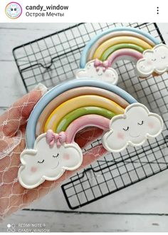 a person holding up some fake rainbows and clouds in their hand with the caption candy window