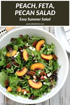 a salad with peaches, pecans and goat cheese in a white bowl on a wooden table