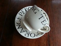 a coffee cup and saucer sitting on top of a wooden table