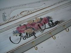 the name vintage written with flowers on an old white box