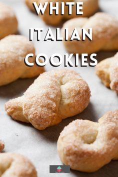 white italian cookies on a baking sheet with text overlay