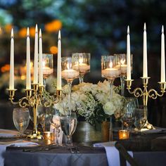 a table topped with lots of candles and flowers