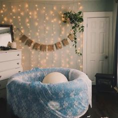 a bedroom with a bean bag chair and string lights