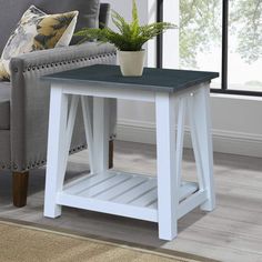 a living room with a gray couch and white end table