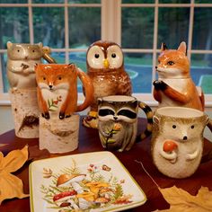 an assortment of ceramic figurines sitting on top of a table