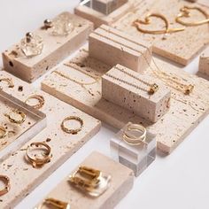 there are many different types of jewelry on the display table with each one's own ring