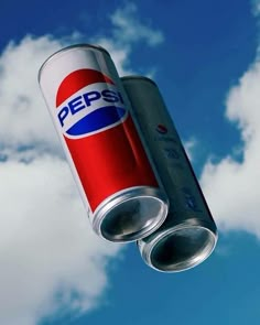 a pepsi can flying through the air in front of a blue sky with white clouds