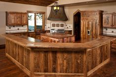 a large kitchen with wooden cabinets and an island