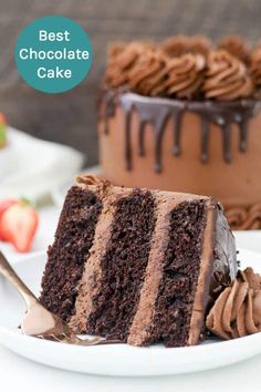 a slice of chocolate cake on a plate with a fork next to it and the rest of the cake in the background