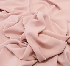 a close up view of a pink fabric with very soft folds on the top and bottom