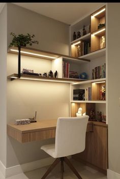 a desk and chair in a room with built - in bookshelves on the wall