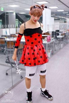 a woman in a red and black polka dot dress