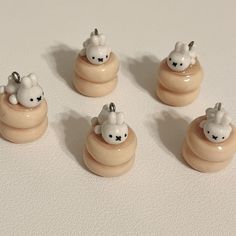 six small ceramic animals sitting on top of a white countertop next to each other