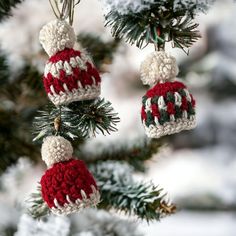 three knitted christmas ornaments hanging from a tree