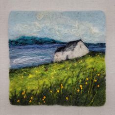 a painting of a house sitting on top of a grass covered hill next to the ocean