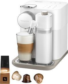 an espresso machine with milk and chocolates next to it