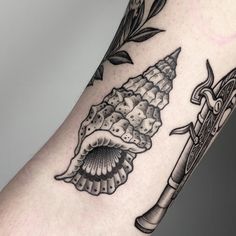 a close up of a person's arm with tattoos on it and an umbrella