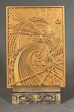 an intricately carved wooden sculpture with gold paint