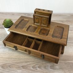 a wooden box with compartments on top of it