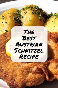 the best austrian schnitzel recipe on a white plate with lemons and parsley