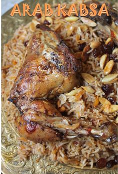 a close up of a plate of food with rice and meat on it, the words araba kabsa written in large letters