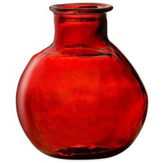 a red glass vase sitting on top of a white table