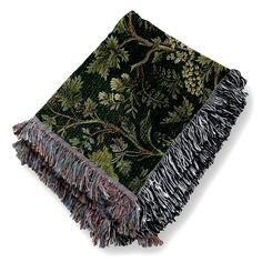 a green and black blanket with fringes on it