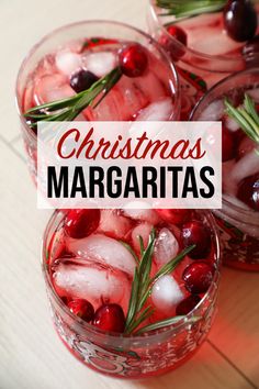 three glasses filled with ice and cranberries on top of a wooden table in front of the words christmas margaritas