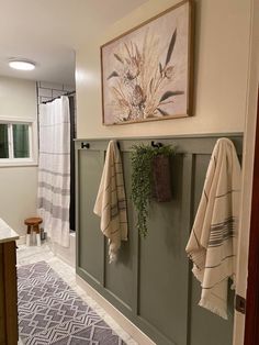 a bathroom with towels hanging on the wall