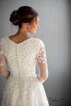 a woman in a wedding dress looking back