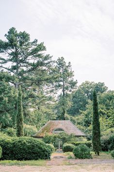 the house is surrounded by trees and bushes