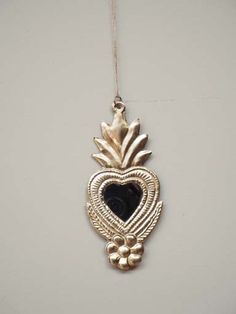 a heart shaped pendant hanging from a chain