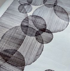 an abstract black and white photo with circles on the fabric, as well as lines in the background