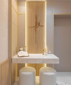 two stools sit in front of a white counter