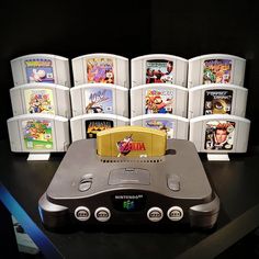 a nintendo game system sitting on top of a table next to other video game consoles