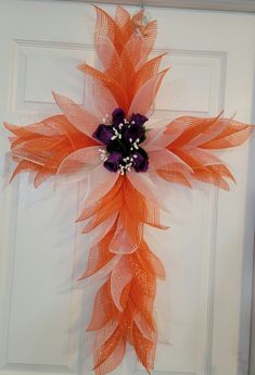 an orange and purple wreath on the front door