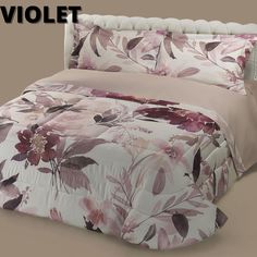 a bed with pink and purple flowers on it