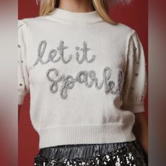 a barbie doll wearing a sweater with the words let it sparkle on it's chest