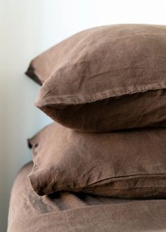 two brown pillows stacked on top of each other