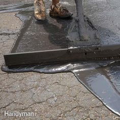 a person standing on top of a tarp next to a puddle filled with water